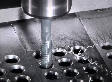 Tapping threads into a punched plate