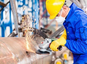 Steel pipe being cut with sparks